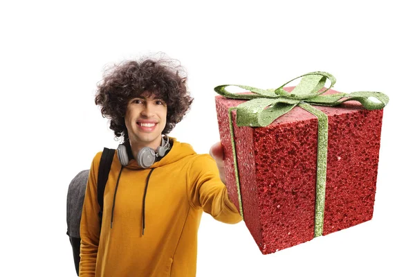 Cheerful Male Student Carrying Backpack Showing Gift Box Isolated White — Stockfoto