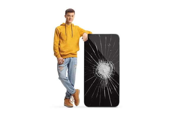 Guy Leunend Een Grote Mobiele Telefoon Met Verpletterd Scherm Geïsoleerd — Stockfoto