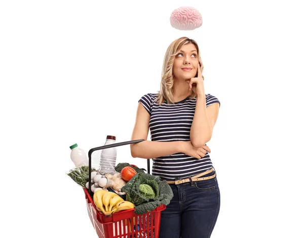 Clever Young Woman Holding Shopping Basket Brain Floating Her Head — Stock Photo, Image