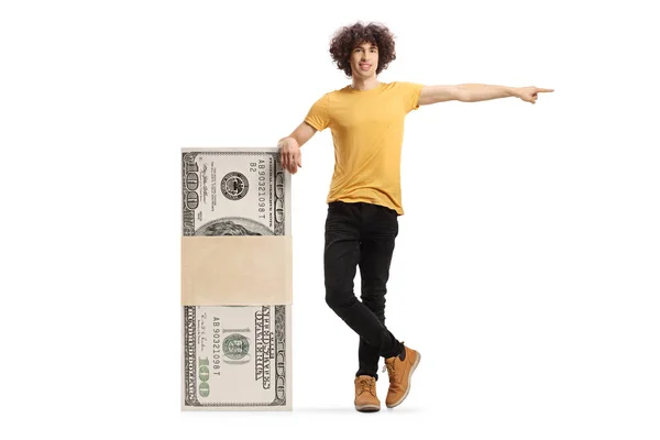 Young Man Leaning Stack Money Pointing Isolated White Background — Stockfoto