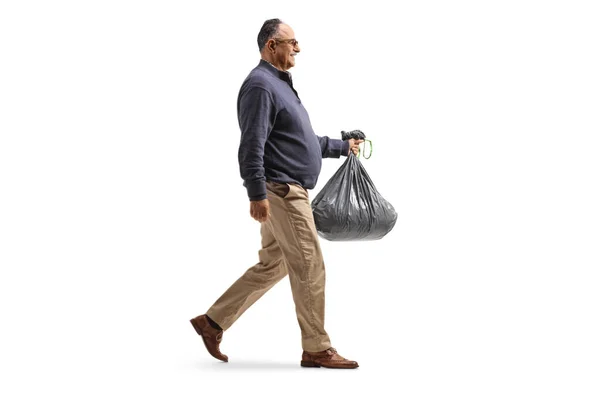 Full Length Profile Shot Mature Man Plastic Waste Bag Walking — Zdjęcie stockowe