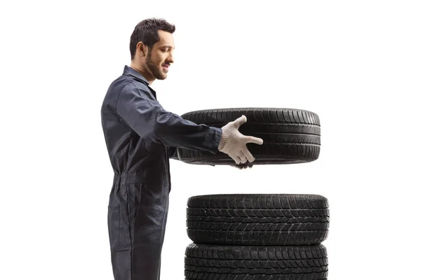 Profile Shot Auto Mechanic Putting Car Tires Pile Isolated White — Stockfoto
