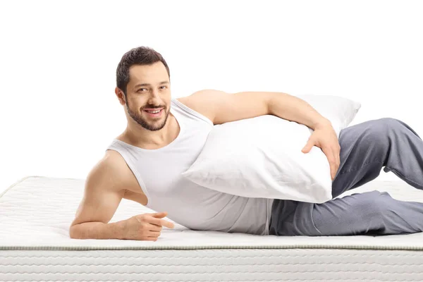 Man Lying Mattress Holding Pillow Isolated White Background — Stockfoto