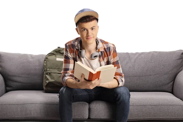 Guy Sitting Sofa Holding Book Looking Camera Isolated White Background — ストック写真