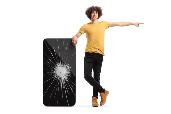 Guy Leaning Broken Smartphone Pointing Isolated White Background — Zdjęcie stockowe