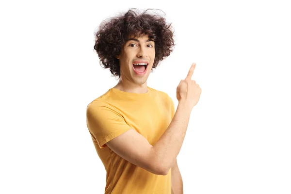 Excited Casual Guy Curly Hair Pointing Isolated White Background — ストック写真