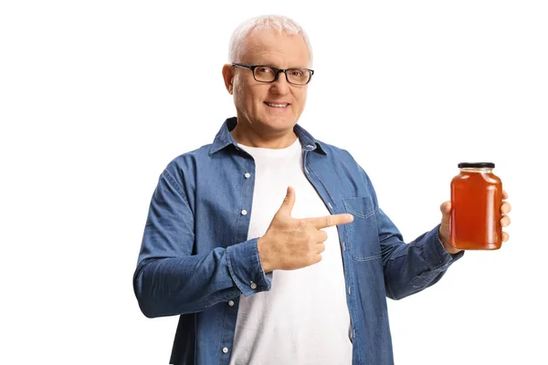 Mature Man Holding Jar Honey Pointing Isolated White Background — Stockfoto