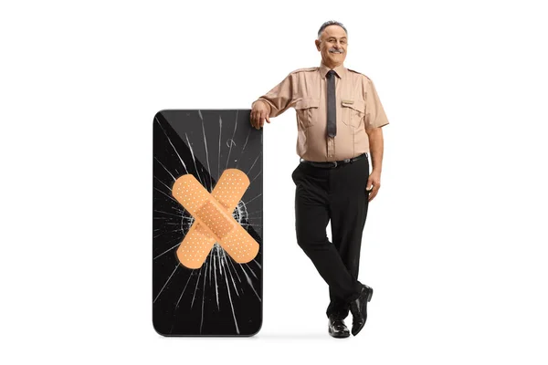 Security Guard Leaning Broken Smartphone Fixed Adhesive Bandage Isolated White — ストック写真