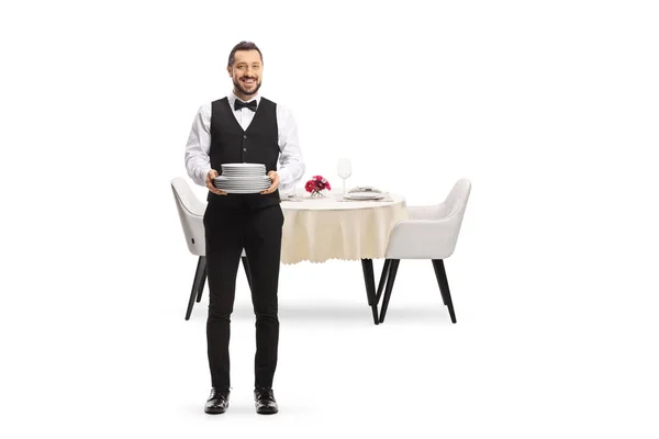 Full Length Portrait Server Holding Pile Plates Standing Front Table — Stockfoto