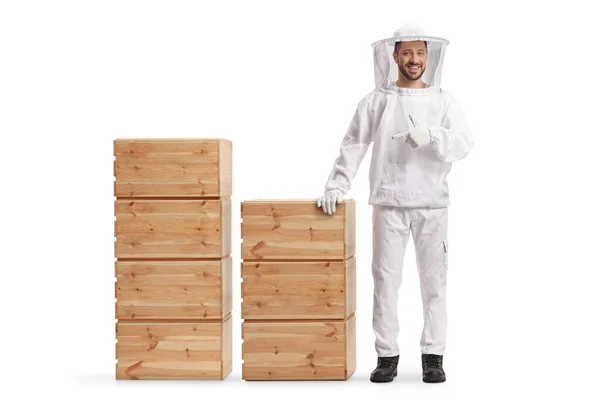 Young Male Bee Keeper Uniform Standing Next Wooden Crates Pointing — Stock Fotó