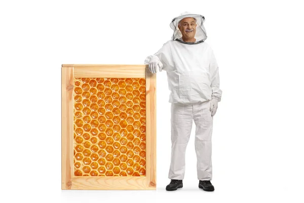 Mature Male Bee Keeper Uniform Leaning Honeycomb Frame Isolated White — Stockfoto