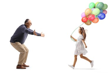 Full length profile shot of a mature man waiting to hug a girl with balloons isolated on white background