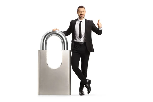 Businessman Leaning Big Padlock Gesturing Thumbs Isolated White Background — Fotografia de Stock
