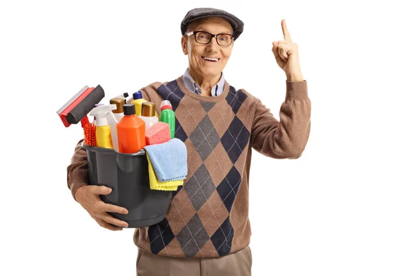 Elderly Man Holding Bucket Cleaning Supplies Pointing Isolated White Background — Stock fotografie