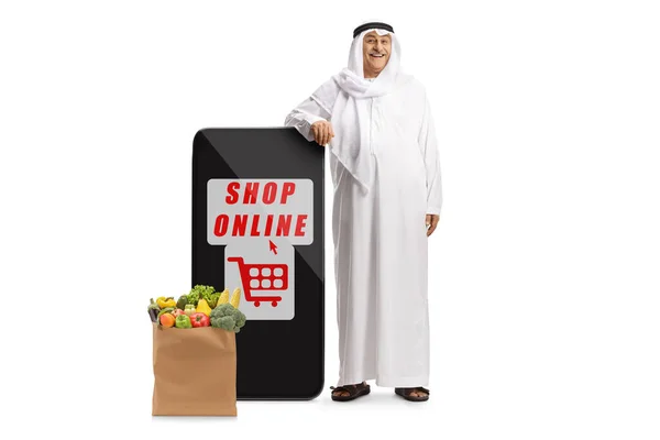 Arab Man Ethnic Clothes Leaning Mobile Phone Grocery Bag Shop — Stockfoto