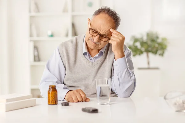 Mature Man Headache Sitting Table Bottle Pills Glass Water — Stok fotoğraf