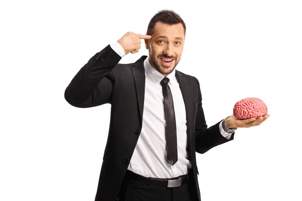 Businessman Holding Human Brain Model Pointing His Head Isolated White — Φωτογραφία Αρχείου