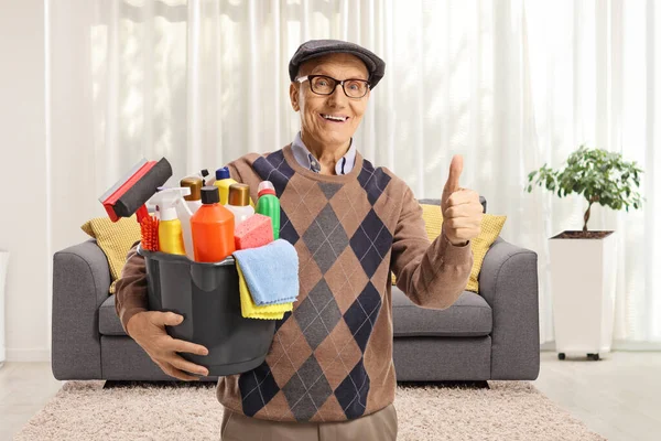 Elderly Man Bucket Cleaning Supplies Standing Living Room Gesturing Thumbs — Stockfoto