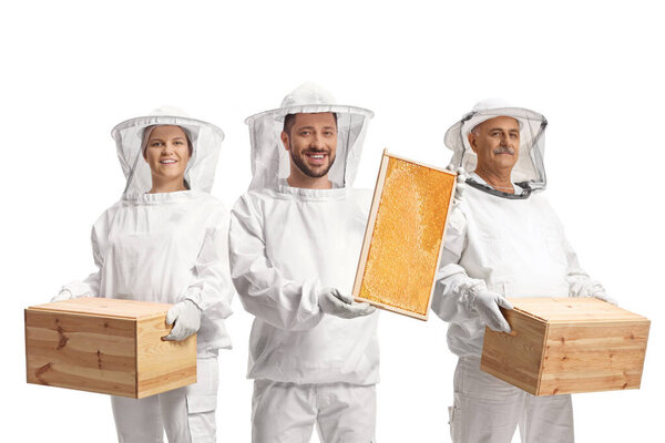 Bee keepers holding a honeycomb frame and wooden boxes isolated on white background
