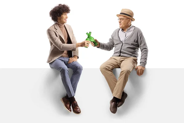 Elderly Man Young Man Sitting Blank Panel Toasting Bottles Beer — Stock Photo, Image