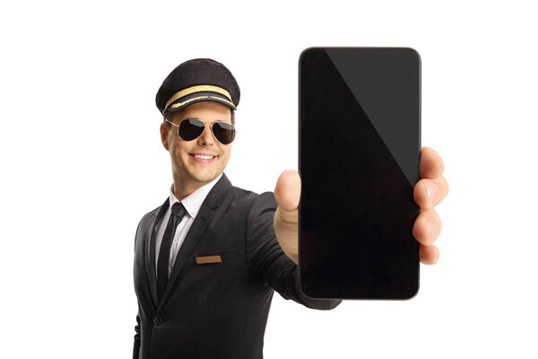 Professional young chauffeur holding a smartphone in front of camera isolated on white background