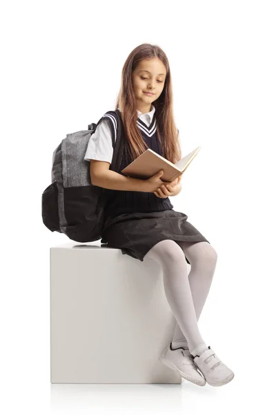 Schoolgirl Sitting Reading Book Isolated White Background — Stockfoto