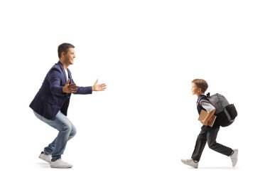 Full length profile shot of a schoolboy running to hug his father isolated on white background