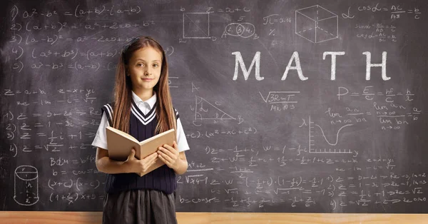 Schoolgirl Book Standing Front Chalkboard Math Formulas —  Fotos de Stock
