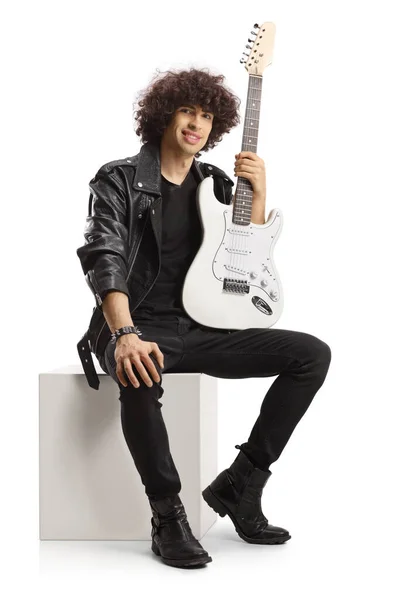 Smiling Young Rock Musician Holding Guitar Sitting White Cube Isolated — Stock Photo, Image