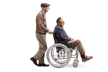 Elderly man pushing a mature man in a wheelchair isolated on white background