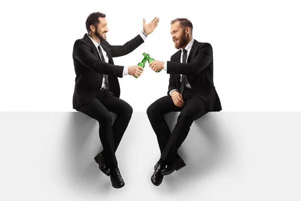 Businessmen Sitting Blank Panel Toasting Bottles Beer Isolated White Background — Stok Foto