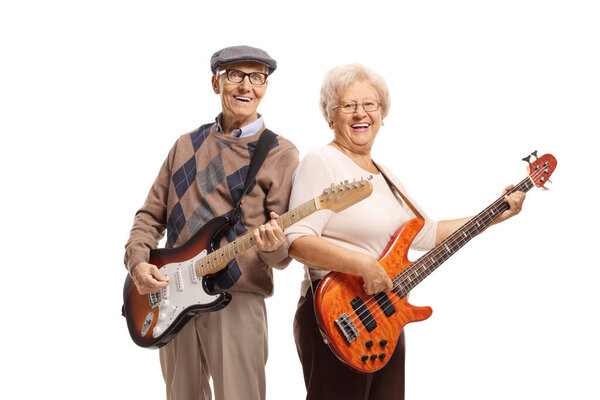 Elderly man and woman playing electric guitars and smiling isolated on white background