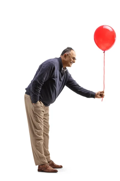 Full Length Profile Shot Mature Man Giving Red Balloon Isolated — Foto de Stock