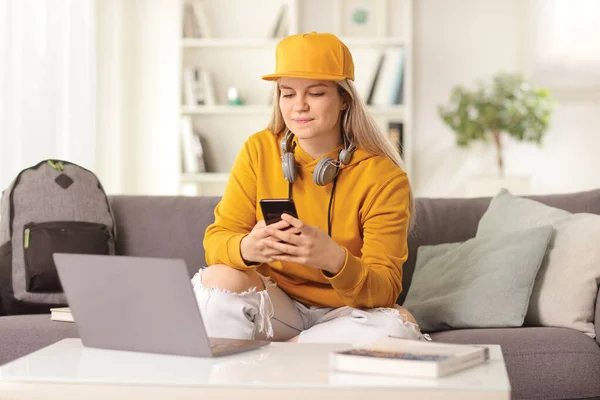 Young Female Sitting Front Laptop Computer Home Using Smartphone — Foto de Stock