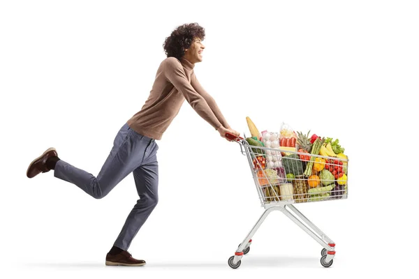 Full Length Profile Shot Young Man Running Shopping Cart Isolated — Stok fotoğraf