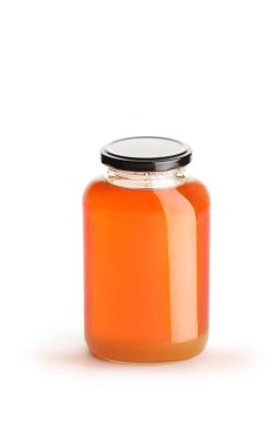 Studio shot of a jar of honey with a black lid isolated on white background