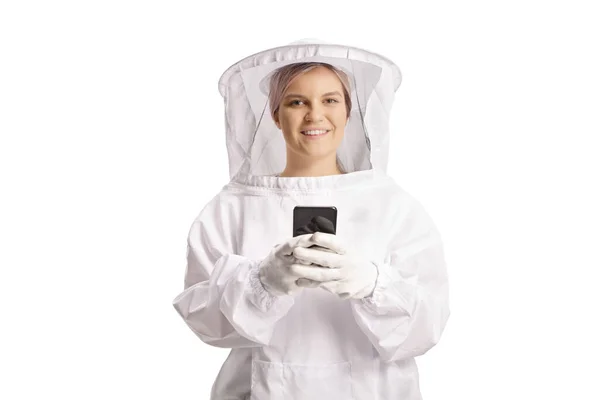 Young Female Bee Keeper Uniform Holding Smartphone Looking Camera Isolated — Stok fotoğraf