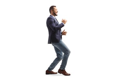 Full length profile shot of a happy professional man in suit and jeans dancing isolated on white background
