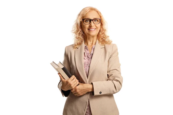 Mature Female Teacher Holding Books Smiling Isolated White Background — Stockfoto