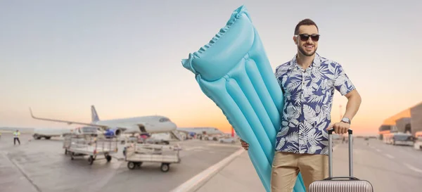 Young Male Tourist Holding Inflatable Mattress Posing Airport Runway — Stok fotoğraf