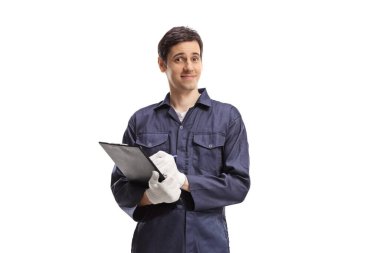 Young male worker in a uniform holding a clipboard isolated on white background