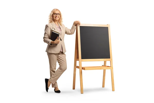 Full Length Portrait Female Teacher Holding Books Standing Next Blackboard — Foto Stock