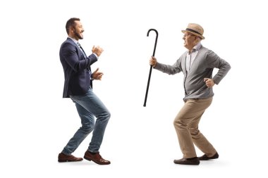 Full length profile shot of a young professional man dancing with a senior man isolated on white background