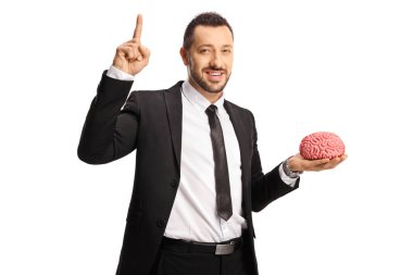 Businessman holding a human brain and pointing up isolated on white background