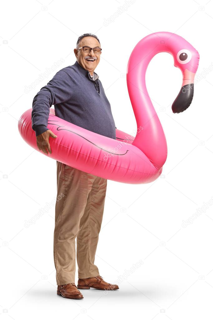 Mature man with a big inflatable flamingo rubber ring isolated on white background