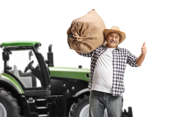 Mature Farmer Sack Gesturing Thumbs Front Tractor Isolated White Background — Stock Photo, Image