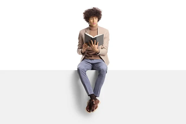 Elegant Young Man Curly Hair Sitting Panel Reading Book Isolated — Stock Photo, Image