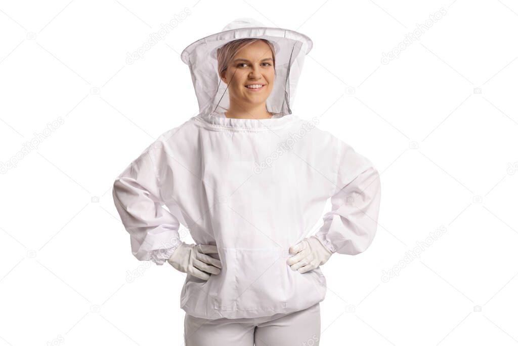 Young female bee keeper in a uniform smiling and looking at camera isolated on blue background