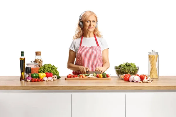 Woman Cutting Vegetables Wooden Counter Listening Music Headphones Isolated White — Stock Photo, Image