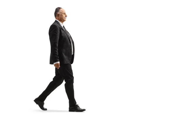 Full Length Profile Shot Mature Businessman Black Suit Walking Isolated — Zdjęcie stockowe
